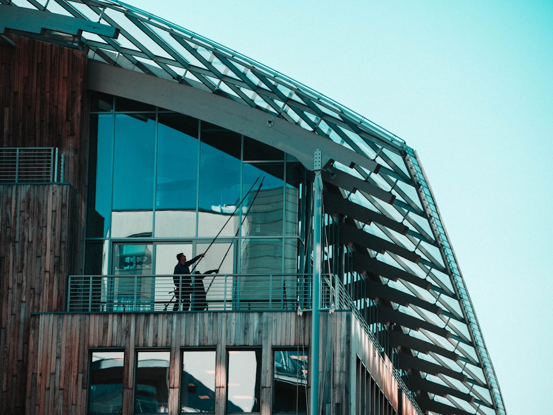 why-choose-us a-man-standing-on-a-balcony-of-a-building-npcikvoa1sy